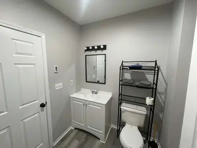 a bathroom with a toilet and a sink and a mirror at Private Apartment in Southbury 104 in Southbury