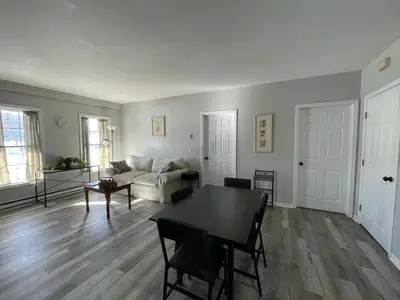a living room with a table and a couch at Private Apartment in Southbury 104 in Southbury