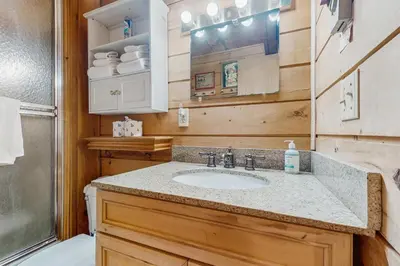 a bathroom with a sink and a toilet and a shower at Ahmeek Retreat in Dover