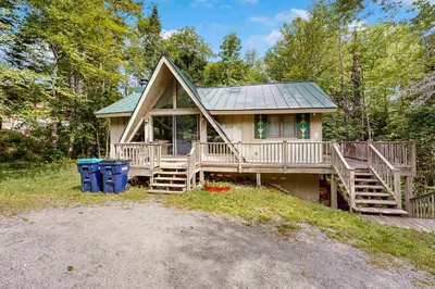 a home with a large porch and a deck at Ahmeek Retreat in Dover