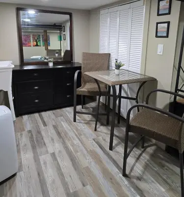 a dining room with a table and a mirror at The Nook Suite in Hackensack