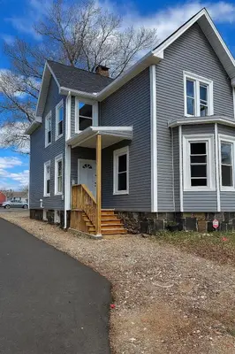 a gray house with a porch and a driveway at Downtown Haven Walk to Yale Renovated Parking in New Haven