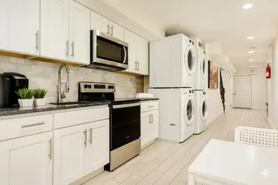 a kitchen with white cabinets and white appliances at Bright Downtown Room near Yale & East Rock! in New Haven