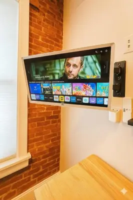 a flat screen tv hanging on a wall at Bright Downtown Room near Yale & East Rock! in New Haven