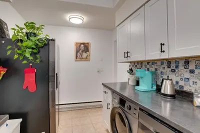 a kitchen with a black refrigerator and a dishwasher at Cozy Condo Jersey City in Jersey City