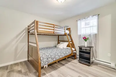 a bedroom with a bunk bed and a window at Family Cabin with Hot Tub Game Room Tobyhanna in Tobyhanna