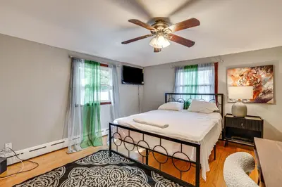 a bedroom with a bed and a ceiling fan at 2 Mi to Town Home with Patio and Yard in Waterbury! in Waterbury
