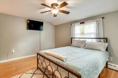 a bedroom with a bed and a ceiling fan at 2 Mi to Town Home with Patio and Yard in Waterbury! in Waterbury