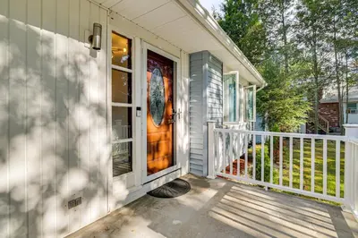 a front door of a house with a porch at 2 Mi to Town Home with Patio and Yard in Waterbury! in Waterbury