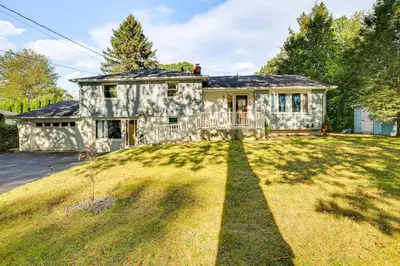 a stone house with a large yard at 2 Mi to Town Home with Patio and Yard in Waterbury! in Waterbury