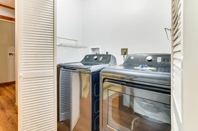 a kitchen with two washer and dryers in a room at Long Pond Log Cabin with Hot Tub Soaks and Outdoor Fun in Long Pond