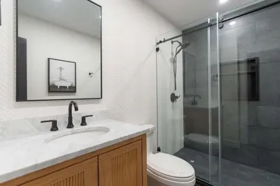 a bathroom with a shower and a sink and a toilet at Modern Catskills Retreat with Creek & Fire Pit in Cairo