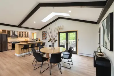 a kitchen and dining room with a table and chairs at Modern Catskills Retreat with Creek & Fire Pit in Cairo