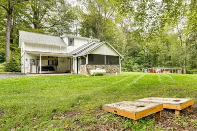a house with a yard with a table in the grass at Pet-Friendly Cottage, 2 Mi to Saugatuck Falls in Redding