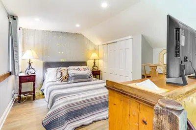 a bedroom with a bed and a flat screen tv at Pet-Friendly Cottage, 2 Mi to Saugatuck Falls in Redding