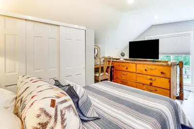 a bedroom with a couch and a dresser with a tv at Pet-Friendly Cottage, 2 Mi to Saugatuck Falls in Redding