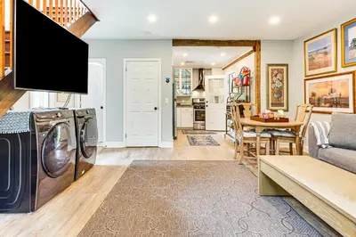 a living room with a washer and dryer at Pet-Friendly Cottage, 2 Mi to Saugatuck Falls in Redding