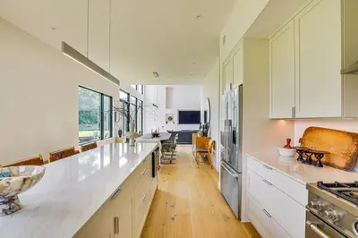 a kitchen with white cabinets and a large counter top at On-Site Sledding! Hudson Valley Winter Escape in Pine Plains