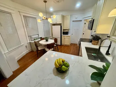 a kitchen with a table with a bowl of fruit on it at 20 min NYC-Modern Private Room-Queen Bed-Parking Available But Confirm with Hosts in Jersey City