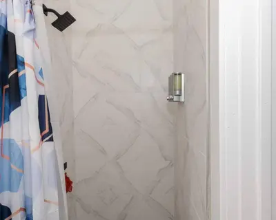 a bathroom with a shower with a shower curtain at Albany Studio with Kitchen, WiFi, Gym and Game Room Near Capitol in Albany