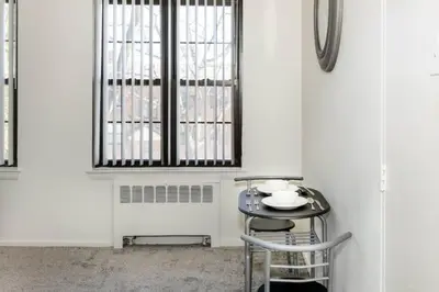 a dining room with a table and a window at Spacious 1-Bedroom Condo with Kitchen, Free Parking and Fitness Center in Albany