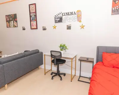 a bedroom with a couch and a desk and a bed at Central Albany Apartment with WiFi Walk to Capitol and Empire Plaza in Albany
