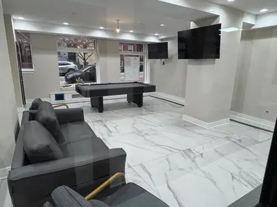 a living room with a couch and a pool table at Central Albany Apartment with WiFi Walk to Capitol and Empire Plaza in Albany
