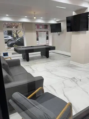 a living room with a ping pong table and couches at Central Albany Apartment Private Unit Near Capitol and Empire Plaza in Albany