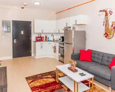 a living room with a couch and a table at Central Albany Apartment Private Unit Near Capitol and Empire Plaza in Albany