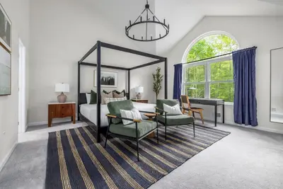 a bedroom with a canopy bed and a table and chairs at Best Deal in the Poconos! in Tobyhanna