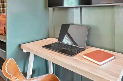 a laptop computer sitting on a table with a book at Lakelyn Lodge in Lakeville