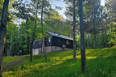 a barn in the woods with trees at Views, Pines & Perfect Vibes in Middleburgh