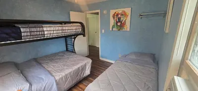 a bedroom with two bunk beds and a mirror at Views, Pines & Perfect Vibes in Middleburgh