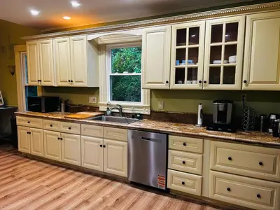 a kitchen with white cabinets and a sink and a window at Historic Springfield Home in Springfield