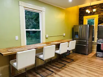 a kitchen with a table and chairs and a refrigerator at Historic Springfield Home in Springfield