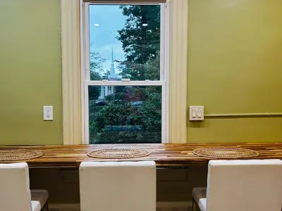 a table with chairs and a window in a room at Historic Springfield Home in Springfield