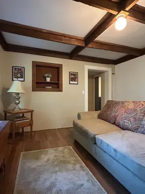 a living room with a bed and a table at The Allen House in North Adams