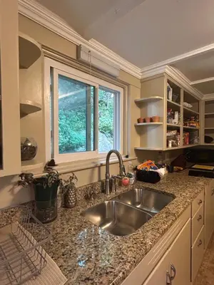 a kitchen with a sink and a window at The Allen House in North Adams