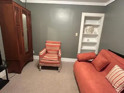 a living room with a couch and a chair at The Allen House in North Adams