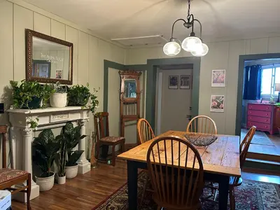 a dining room with a wooden table and chairs at The Allen House in North Adams