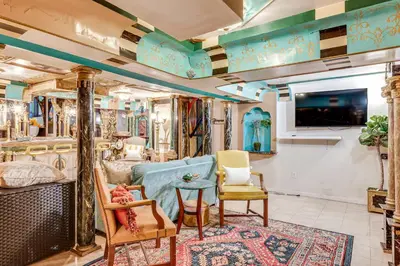 a room with a couch and chairs and a tv at A Retreat in an Historic Estate with Modern Comforts in Scranton