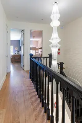 a staircase in a home with a stair light at Massive NYC Brownstone wPatio in New York