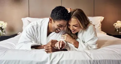 a man and a woman laying on a bed at The Livingston, part of JdV by Hyatt in Brooklyn