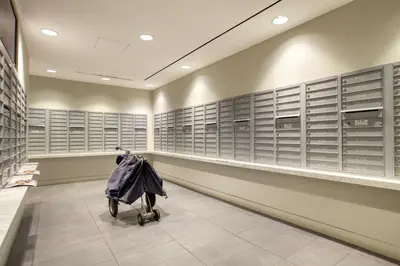 a room with lockers and a shopping cart in a store at Blueground Murray Hill balcony nr East River NYC-720 in New York