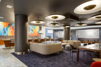 a lobby with a waiting area with chairs and tables at Blueground Murray Hill balcony nr East River NYC-720 in New York