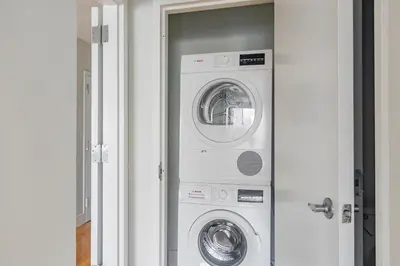 a white washer and dryer in a room at Blueground Lenox Hill view nr Central Park NYC-2019 in New York