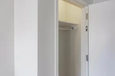 a white closet with a door and a shelf at Blueground Lenox Hill view nr Central Park NYC-2019 in New York