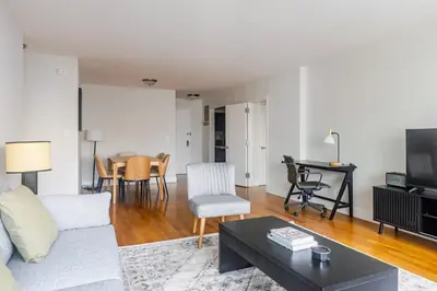 a living room with a couch and a table at Blueground Lenox Hill view nr Central Park NYC-2019 in New York