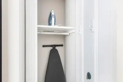 a black tie hanging on a hook in a door at Blueground Nolita private entrance nr Bowery NYC-2054 in New York