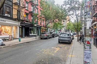 a city street with cars parked on the street at Blueground Nolita private entrance nr Bowery NYC-2054 in New York